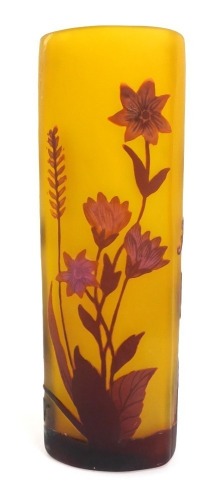 A Galle style glass vase, of curved triangular form, with floral cameo decoration in purple against a frosted yellow ground, 21cm high.