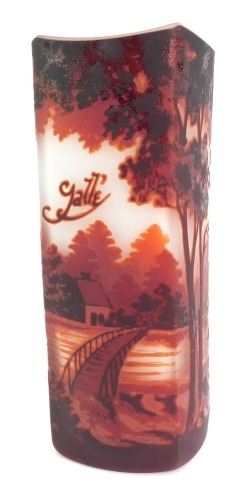 A Galle style glass vase, of elongated square shaped form, cameo decorated in purple with a bridge over a lake with houses to the background amongst trees, against a white frosted ground, 20.5cm high.