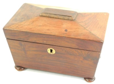 A Regency rosewood sarcophagus shaped tea caddy, the hinged lid enclosing two lidded compartments, on compressed bun feet, 13cm high, 20cm wide, 11cm deep.