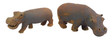 A pair of early 20thC studio pottery figures modelled as hippos, indistinctly signed to underside, 25cm long and 22cm long respectively.