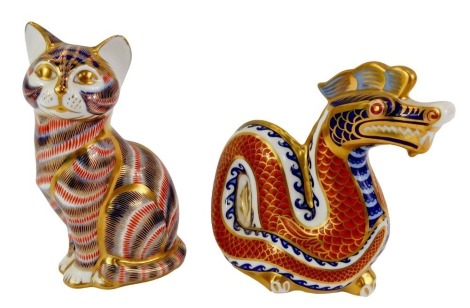 Two Royal Crown Derby porcelain paperweights, modelled as dragon, 11.5cm high, and seated cat, 13cm high, each with red printed marks and silver stoppers.