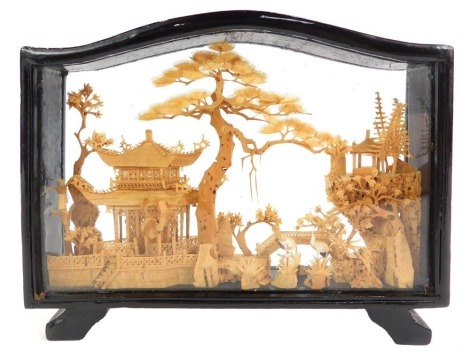 A Chinese carved cork picture, depicting storks before pagodas, with trees, in a black frame, 14.5cm high.