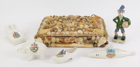 A shell encrusted 20thC jewellery box, with green baize lining, 4cm high, 24cm wide, 19cm deep, four items of crested ware, to include Southport pig, Bournemouth boot, Kirkcaldy submarine, and Bury St Edmunds cheese dish and cover, and an Arry...