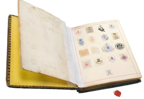 A 19thC and later album, containing painted crests from letters, the book belonging to Ellen M J Kirkman, dated November 1869.