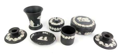 A collection of Wedgwood black Jasperware, comprising two squat candle stands, trinket dish, octagonal stylised trinket dish and cover, and two vases. (7)