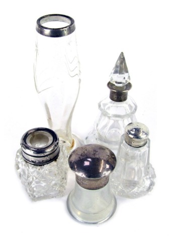 Five Edward VII and later silver topped cut glass bottles and jars, including a scent bottle and stopper, 12cm high, smelling salts bottles, 6cm high, together with a stem vase, 15cm high, etc.