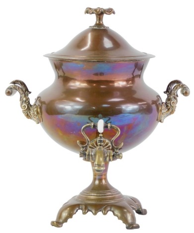 A 19thC copper and brass samovar, with floral finial and two scroll cast handles, with two scroll cast handles with milk glass insulators and brass tap, 37cm high.