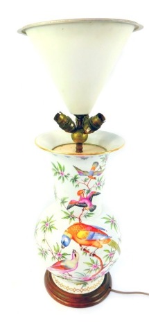 A late 19thC German porcelain vase, of bulbous form, with elongated neck and flared rim, decorated with exotic birds and flowering branches, with gilt highlights, later converted to a table lamp, on a turned hardwood base, with central uplighter,...