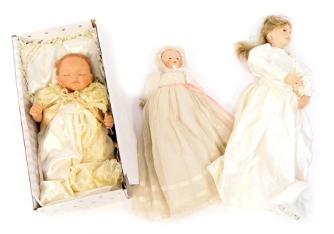 A group of dolls, comprising an Ashton Drake Galleries Prince George of Cambridge doll, boxed, together with a bisque porcelain baby doll, and another of a lady in white dress wearing ice skates.