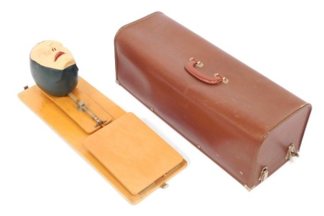 A mid century CPR model, depicting a female face mounted on hardwood board, with outer case, 62cm long.