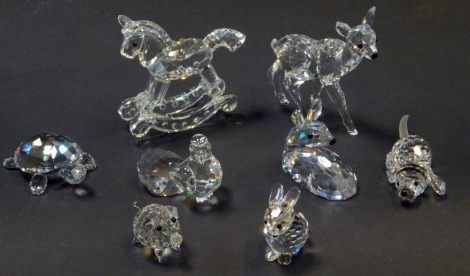 A group of Swarovski crystal figures, comprising rocking horse, standing deer and seated deer, tortoise, puppy, pig, rabbit, and dove.