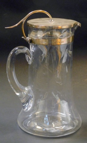 An Edward VII silver topped claret jug, the silver lid with a moulded thumb piece and silver collar, on a twist glass stem vase, stamped Maple and Co London, maker NW, Birmingham 1909, 26cm high.