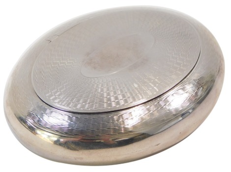 An Edward VII silver tobacco box, of oval form, with engine turned decoration, vacant oval reserve, Birmingham 1906, 2.89oz.