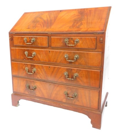 A 20thC mahogany and flamed mahogany bureau in George III style, the fall enclosing an arrangement of recesses and drawers above two short and three long drawers, on bracket feet, 97cm high, 89.5cm wide, 45cm deep.