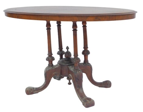 A Victorian walnut and inlaid occasional table, the oval top with floral scroll and line inlay decoration, on four fluted cylindrical carved columns with rounded foliate carving, on four leaf carved cabriole legs with pad feet, 62cm high, the top...