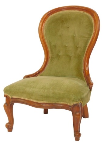 A Victorian mahogany spoon back nursing chair, with green draylon overstuffed seat and back, on cabriole legs.