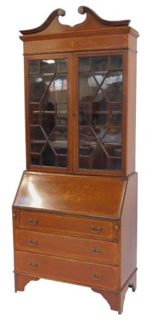 A late 19thC mahogany and inlaid bureau bookcase, the top with swan neck pediment above a marquetry inlaid frieze above two astragal glazed doors enclosing three shelves, the base with an inlaid fall with Adam Revival motifs enclosing an...