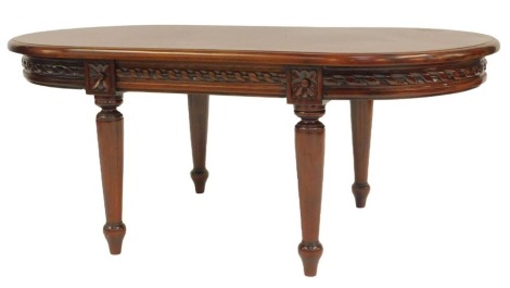 A 20thC mahogany coffee table, the oval top above a flower head and repeat twist pattern edge, on cylindrical tapering fluted legs, 45cm high, the top 110cm x 62cm.