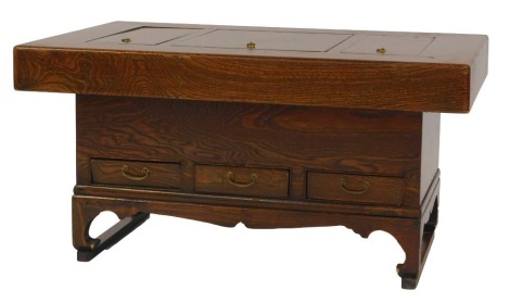 A Korean elm Hibachi, the top with three removable sections enclosing copper dishes, the base with three shallow frieze drawers, on shaped feet united by stretcher, 48cm high, 90cm wide, 59cm deep.