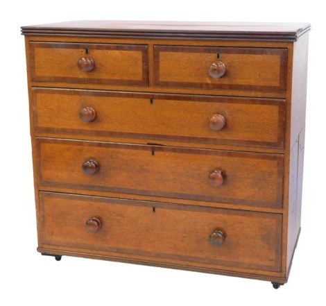 A Victorian oak and cross banded chest, of two short and three long drawers, on castors, 99cm high, 101cm wide, 53.5cm deep.