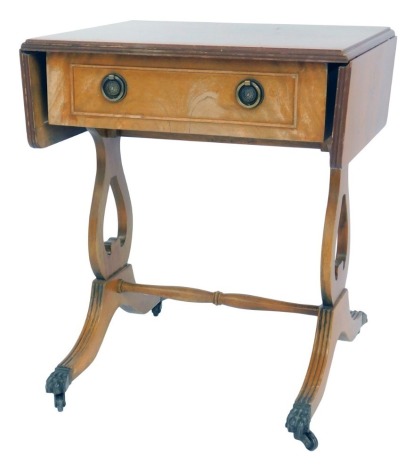 A mahogany drop leaf side table, in Regency style, the top with a moulded edge with frieze drawer, on lyre side supports, with reeded out swept legs united by a turned stretcher, on lion paw capped castors, 52cm high, the top 54cm x 37cm, 74cm...