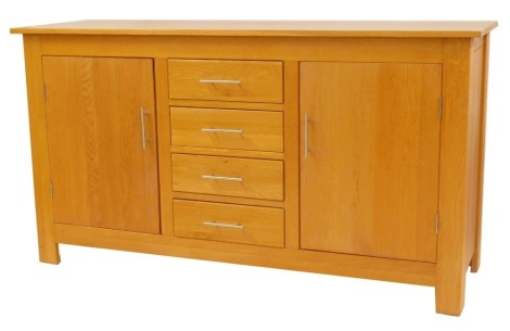 A contemporary oak sideboard, the rectangular top above four central doors flanked by two cupboards, on stiles, 90cm high, 166cm wide, 53cm deep.