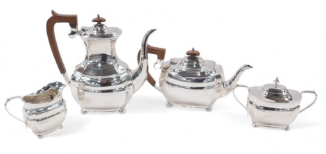 An Elizabeth II silver four piece tea and coffee set, of oval bombe design, with bun feet, comprising teapot, coffee pot, with composition handles, lidded sugar basin, and milk jug, makers Roberts & Belk, 62.37oz. all in.