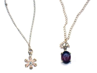 Two pendants and chains, comprising a 9ct gold fine link neck chain with a garnet set pendant, the pendant 1cm high, the chain 36cm long, and a further 9ct gold pendant and chain with cluster pendant, the chain 40cm long, 3.1g all in. (2)