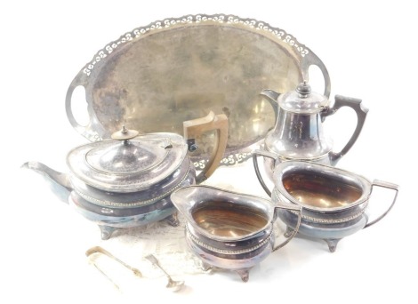 A silver plated three piece tea set, oval tray, and hot water jug.