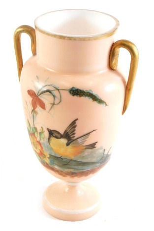 A Victorian opaque glass two handled vase, painted with birds and flowers, on a coral coloured ground, 25cm high.