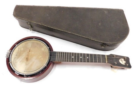 A Keech banjulele banjo, with an ebony finger board, etc., the skin described indistinctly Blackpool, in simulated reptile skin case.