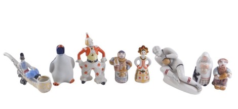 A collection of USSR and Russian porcelain, comprising seated figure of a goal keeper, penguin decanter, lady and cat with carrying vessel, female in headdress stamped Ayaebo, pair of studio pottery figures, etc. (8)