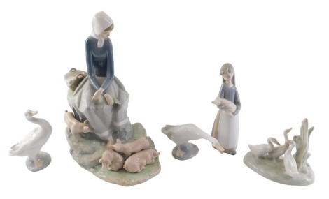 A Lladro porcelain figure group, modelled in the form of a lady with pigs, and other Lladro.