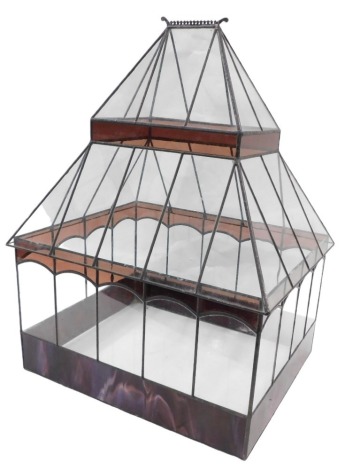 A leaded glass terrarium, the base with purple marbled stained glass panels with an arched roof, 65cm high, 46cm wide, 39cm deep.