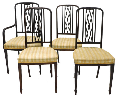 A set of four Edwardian mahogany salon type chairs, each with a lattice shaped back, a padded seat on square tapering legs, one with arms.