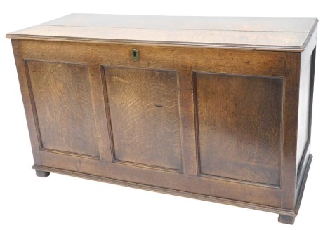 An 18thC oak coffer, the plank top with a moulded edge, enclosing a fitted interior with a candle box, with a triple panelled front, on stiles, 70cm high, 120cm wide.