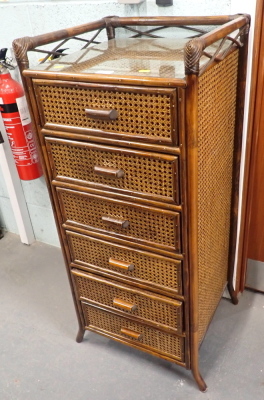 A six drawer rush side table with glass top.