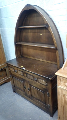 An Old Charm style dresser, with arched back above two shelves, two single drawers with two cupboards, on stiles.