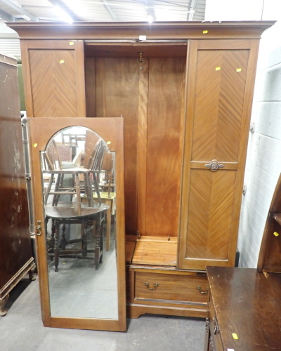 A 20thC mahogany double wardrobe, with mirror glazed door above arrangement of two drawers.