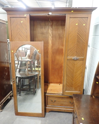 A 20thC mahogany double wardrobe, with mirror glazed door above arrangement of two drawers.