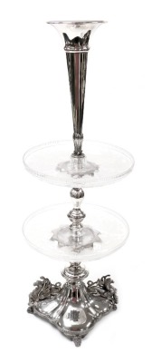 A Victorian silver plate and cut glass table centrepiece, with a fluted trumpet, above two tier glass dishes engraved with acorns and oak leaves, raised on a quatrefoil base, with griffin handles, on four scroll feet, 74cm high.