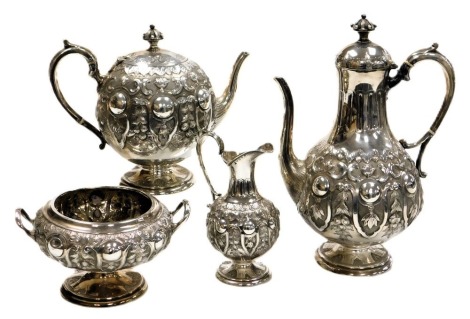 A Victorian silver tea and coffee set, of baluster form, with reeded and embossed decoration of trailing fruit and leaves, comprising tea pot, coffee pot, cream jug and sugar bowl, William & Henry Stratford, Sheffield 1863, 68.33oz.