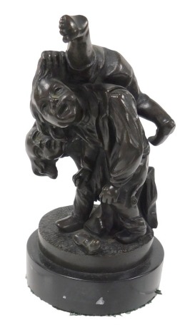 Continental School (19thC). A bronze sculpture of two frolicking boys, on a circular base and black marble or slate socle, 12.5cm high.