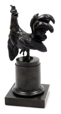 An early 20thC bronze figure of a cockerel, modelled on a circular plinth and square base, 20.5cm high.