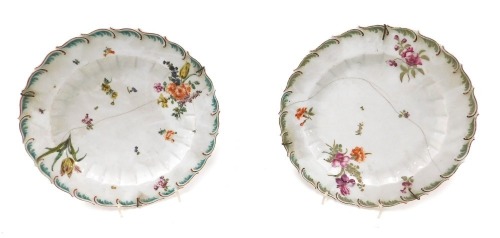 Two late 18thC Chelsea red anchor period porcelain plates, with fluted and leaf moulding, painted with sprays and sprigs of flowers, one bearing anchor mark, 21cm wide. (AF)