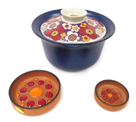 A late 20thC Figgjo Maja pattern casserole dish and cover, Turi-Design, printed marks, 25.5cm wide, together with a pair of Hornsea graduated circular terracotta and enamel dishes, with a red and orange floral design, printed marks, 12.5cm and 8.5cm wide.