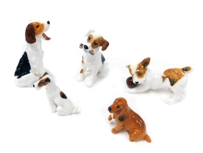 Four Royal Doulton figures of Jack Russell terriers, one with a slipper in its mouth, another with a ball, together with a further Royal Doulton figure modelled as a Cocker Spaniel with a bandaged leg. (5)