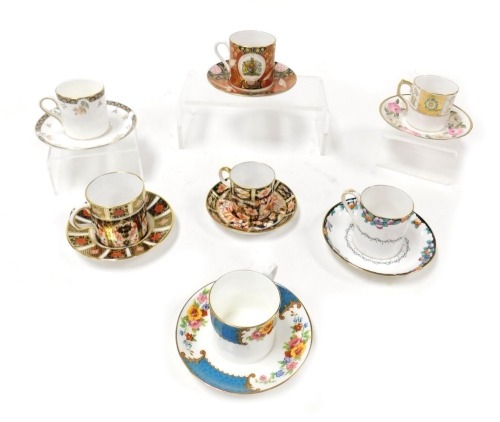 A group of coffee cans and saucers, variously decorated by Royal Worcester, Royal Crown Derby, Royal Doulton and others. (qty)