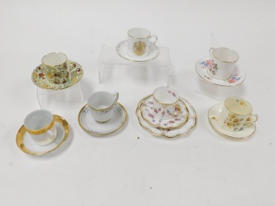 A group of coffee cans and saucers, variously decorated by Royal Worcester, Royal Crown Derby, Royal Doulton and others. (qty) - 4