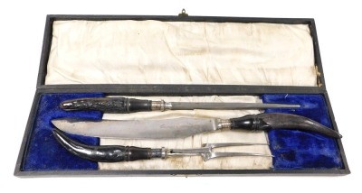 An Edward VII three piece carving set, by S Williamson & Sons, cutlers, Sheffield, with horn handles and silver ferules, cased, Sheffield 1903.